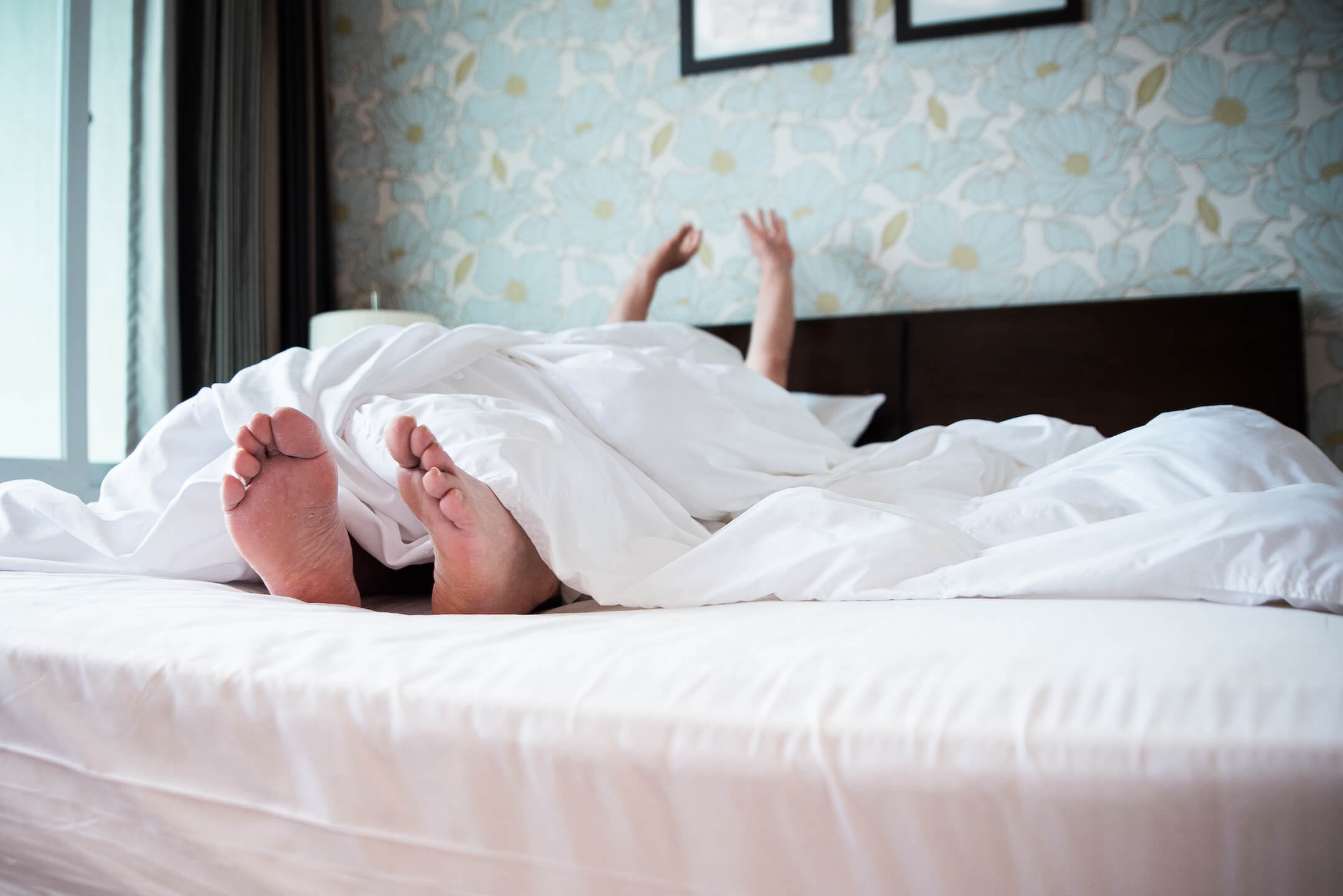 Picture of a person waking up in bed, stretching, getting ready to have a low carb, grain free, gluten free breakfast of JuNula just nuts granola