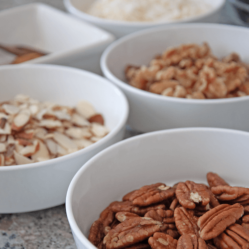 Picture of raw nuts in bowls that are used in JuNula Just Nuts granola
